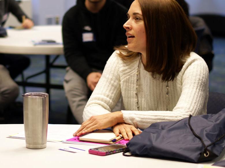 Student talking at table at spring Orientation